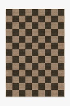 a brown and black checkered rug with white squares on the bottom, in front of a beige background