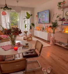 a living room filled with furniture and a flat screen tv mounted to the side of a wall