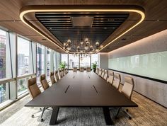 an empty conference room with large windows and chandelier