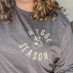 This Hygge Season long sleeve t shirt is a perfect to snuggle up in with a cup of hot cocoa. Wearing this t-shirt will instantly give you Hygge Vibes! We use super soft, high quality Bella Canvas tees. The t-shirt color is Heather Navy. 52/48 airlume combed and ringspun cotton/polyester 2" ribbed cuffs Coverstitched collar These shirts are Unisex & preshrunk, please see size chart in listing photos for sizing information. Cozy Long Sleeve T-shirt With Graphic Print, Cozy Winter T-shirt For Loungewear, Winter Loungewear T-shirt Soft-washed, Casual Long Sleeve Coffee T-shirt, Soft-washed Long Sleeve T-shirt For Loungewear, Everyday Coffee-colored T-shirt With Text Print, Long Sleeve Graphic Print T-shirt For Camping, Camping Text Print Crew Neck T-shirt, Hygge Lifestyle