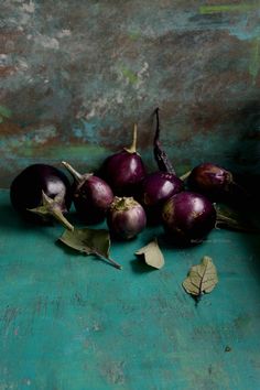 some purple onions are sitting on a green surface