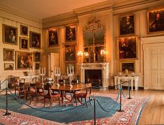 an ornate dining room with paintings on the walls