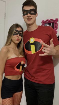 a man and woman in costumes posing for the camera with their hands on their hips