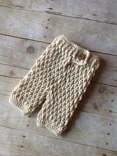 a white crocheted bag sitting on top of a wooden floor