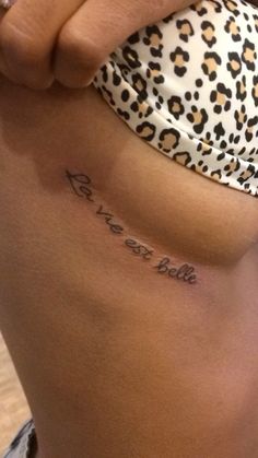 a woman with a tattoo on her stomach that says rest, sleep and be wild