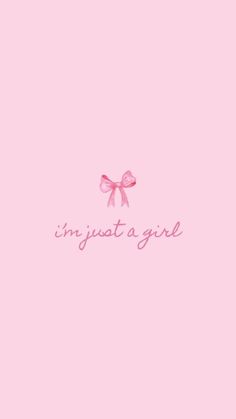 a pink wallpaper with the words in just a girl on it and a bow