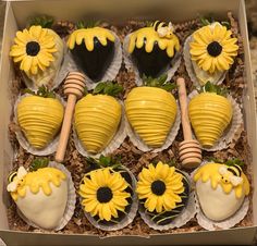 a box filled with chocolate covered strawberries and sunflowers on top of each other