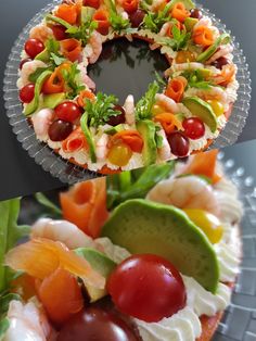 two plates with different types of food on them, one is decorated like a wreath