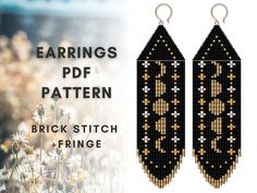 the earrings are made out of black and gold seed beading, with white flowers in the background