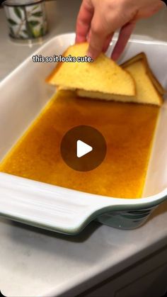 a person is spreading peanut butter on toast in a white dish with a video title above it