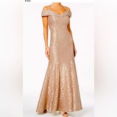 a woman in a gold dress is standing up