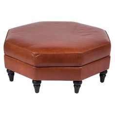 a brown leather ottoman with black legs