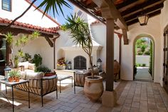 an outdoor living area with patio furniture and potted plants