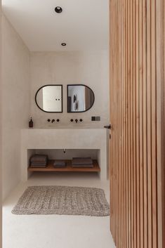 a bathroom with two sinks and mirrors on the wall