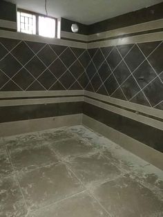 an empty bathroom with tiled walls and floor