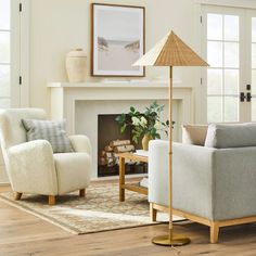 a living room filled with furniture and a fire place in front of a white fireplace