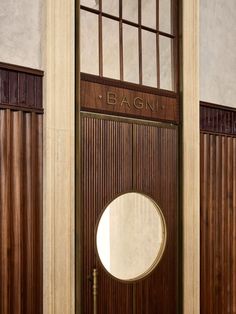 a door with a round mirror on it in front of some wooden panels and doors