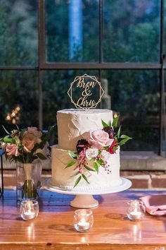 a wedding cake sitting on top of a wooden table