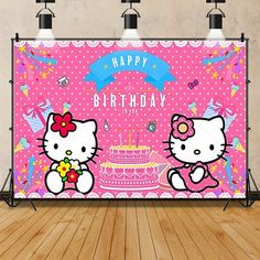 a pink hello kitty birthday backdrop on a wooden floor