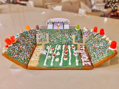 a football field decorated with sprinkles and candies is on the table