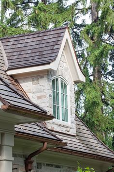 a house with a brown roof and white trim