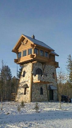 a house made out of rocks in the snow