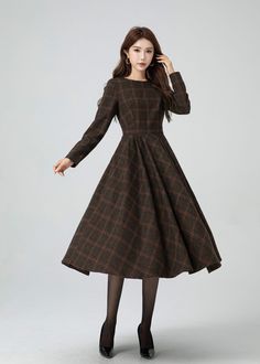 This garment blends timeless elegance with contemporary flair. The cinched waist and flared shape accentuates the waist, and there are pleated details at the waist. The plaid design adds a touch of vintage and sophistication.A must-have for this autumn and winter. DETAIL * 30% wool, 30% fiber, 40% polyester * fully satiny lining, more nice to the touch body * Round neckline * Long sleeves dress * Two side seam pockets * Back zipper closure * Fit and flare dress * Midi wool dress * Plaid wool dre Long Plaid Dress, Thrift Board, Custom Dress, Dress Winter, Thrift Finds, Winter Dress, Sleeves Dress, Dress Midi, Plaid Design