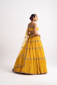 Beautifully hand-embroidered lehenga and blouse with a multi-color mirror work dupatta.From Vvani Vats Rang's collection.DELIVERY TIMEPlease allow 8-12 weeks for your outfit to arrive.FABRIC DETAILSNet, Georgette, Silk BlendProfessional cleaning only. Designer Multicolor Pre-draped Saree With Gota Work, Yellow Chanderi Lehenga With Mirror Work, Yellow Pre-draped Saree With Mirror Work For Reception, Yellow Unstitched Choli With Mirror Work, Multicolor Georgette Pre-draped Saree With Gota Work, Multicolor Floor-length Lehenga With Gota Work, Yellow Dresses With Mirror Work For Reception, Yellow Dola Silk Choli With Mirror Work, Yellow Mirror Work Choli In Dola Silk