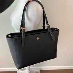 Authentic Tory Burch York Small Buckle Tote In Black Saffiano Leather. Adjustable Handle Length. Zip Middle Compartment. Inside Has Zip And Slip Wall Pockets. A Couple Of Light Marks As Pictured (Not Very Noticeable In Person) & A Loose Thread On Handle As Pictured Otherwise In Great Preowned Condition, Only Carried This Tote Once- It Was Too Small For My Needs. Comes With Tb Dustbag. Tory Burch Robinson Tote, Taupe Bag, Tory Burch Ella Tote, Ella Tote, My Needs, Plaid Tote, Red Tote Bag, Tory Burch Tote, Tory Burch Bag Totes