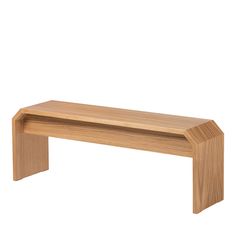 a wooden bench sitting on top of a white wall