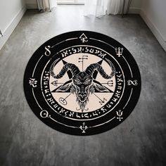 a black and white circular rug with an animal head on the center, surrounded by zodiac signs