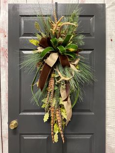 This pine swag is decorated using stems of green sparkle holly, faux deer antlers, artificial feathers, and a beautiful bow to accent all the colors.  The size of this rustic Christmas wreath is approximately 17" x 39".  Click here to see all of my wreaths and door hangers at https://www.etsy.com/shop/TammysCreatedDesigns ❤ CUSTOM: We're happy to create custom products. If you'd like something different, please reach out. ❤ PROCESSING TIME: I try to ship fast, Sometimes the same day if possible but no later than 2 or 3 business days. ❤ SHIPPING TIME: Shipping time depends on the area you are in; I usually ship UPS ground. Note: Free shipping is only available for the lower 48, message me if you need a quote for shipping in Alaska and Hawaii. ❤ GIFTS: You can ship our products directly to y Christmas Mailbox Swag, Historic Christmas, Hawaii Gifts, Christmas Door Swag, Wreaths Winter, Pine Swag, Deer Antler Crafts