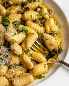 a pasta dish with broccoli and parmesan cheese on the side, ready to be eaten