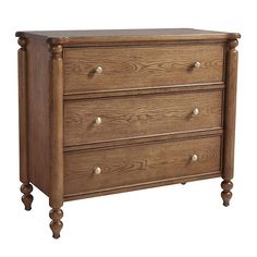 a wooden dresser with three drawers on one side and two knobs on the other