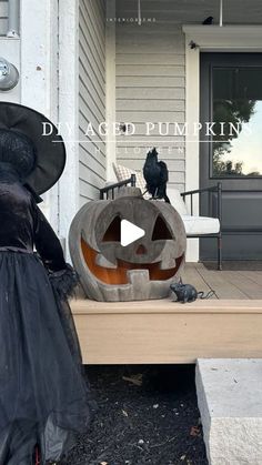 a couple of pumpkins sitting on top of a wooden bench in front of a house