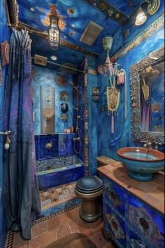 a bathroom with blue walls and tile flooring