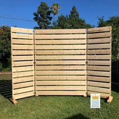 a large wooden fence in the grass