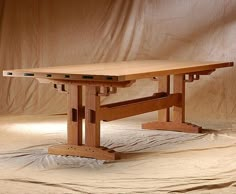 a wooden table sitting on top of a bed