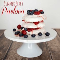 a stack of pavlova with berries on top and the words summer berry pavlova above it