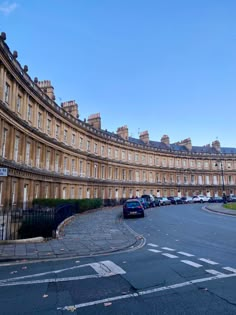 a curved building with many windows and balconies