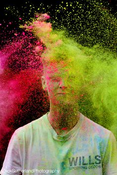 a man standing in front of colored powder