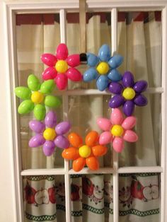 some balloons are hanging on the window sill