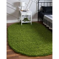 a bedroom with a green rug on the floor