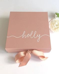 a pink box with the word holly written on it and a rose next to it