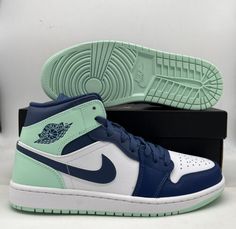 the nike air jordan 1 mid is shown in blue and white with green accents on the upper