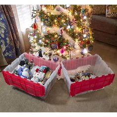 two red baskets filled with toys under a christmas tree