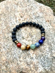 Enhance your energy and style with our Handmade Unisex Chakra Bracelet! Crafted with premium gemstones and 8mm black lava stone beads, this unique piece offers both beauty and balance. The clear stretch cord ensures a comfortable fit on an average wrist size of 7 inches.  Why You'll Love It: - Holistic Healing: Each gemstone is carefully selected to align and balance your chakras, promoting inner peace and well-being. - **Quality Craftsmanship: Handmade in the USA with meticulous attention to de Chakra Bracelet, Lava Stone, Holistic Healing, Atlanta Ga, Versatile Style, Inner Peace, Stone Beads, Favorite Jewelry, Gemstone Jewelry