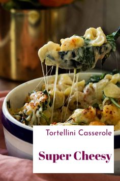 tortelli casserole with spinach and cheese being lifted from a bowl