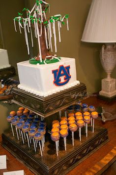 cupcakes and muffins are arranged in front of a cake on a table