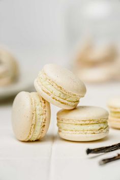 three macaroons sitting on top of each other next to some forks and spoons